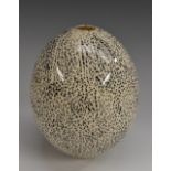 A large 19th century porcelain ornithological novelty, as a speckled ostrich egg, 15cm long,