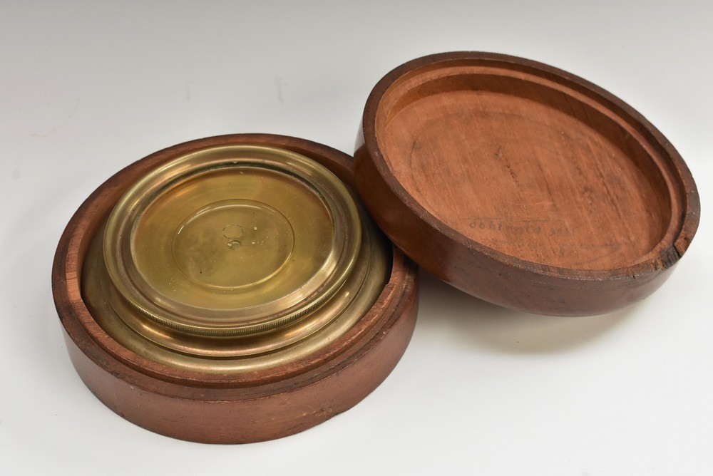 An early 20th century brass and mahogany circular vial spirit level, push-fitting cover, 15.