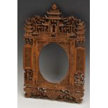 An Chinese carved wooden photograph frame, the crest with pagodas, figures and foliage, 36cm high,