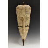 Tribal Art - a Fang Ngil mask, typical concave features with scarified cheeks, 77cm high,