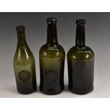A George III olive green glass sealed wine bottle, R Mofeley [Moseley] 1792, kick-up base,