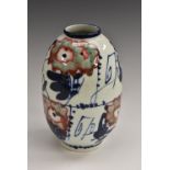 A Japanese porcelain ovoid vase, painted and inscribed in underglaze blue with fast script,