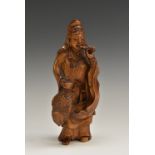 A Chinese boxwood carving, of Guanyin, she stands, holding a fish, 20.