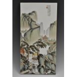 A Chinese porcelain rectangular plaque, painted with figures in a monumental landscape, 31cm x 15.