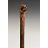 A 19th century gentleman's novelty walking cane, the pommel carved as the head of a dog,
