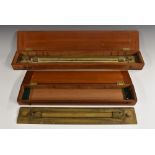 An early 20th century surveyor's brass rolling parallel rule, 46cm wide, mahogany case; another,