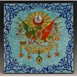 A large Turkish tile, brightly decorated with the coat of arms of the Ottoman Empire,
