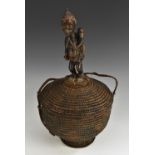 Tribal Art - an Ifugao basket, the cover surmounted by a figure of a mother and child, 44cm high,