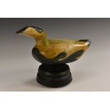 An Eider Duck Decoy on a stand, carved and painted wood, 22cm tall, 20th century.