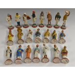 A set of twenty two Indian painted terracotta educational figures, depicting various occupations,