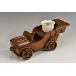 A Black Forest novelty inkstand, as a motor car, the radiator enclosing a drawer,