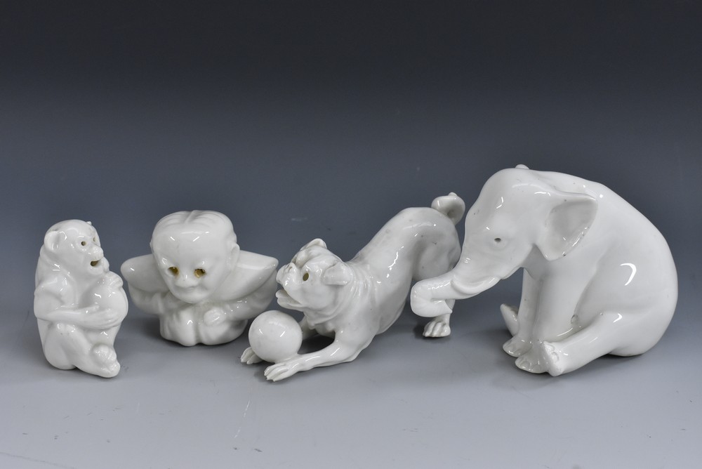 A Bernard Moore novelty miniature model of a seated elephant, glazed in white throughout,