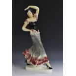 A large continental earthenware model of a Flamenco Dancer, glazed in glossy tones of pink, grey,