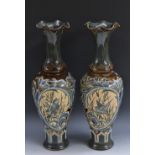 A pair of Doulton Lambeth slender baluster vases,