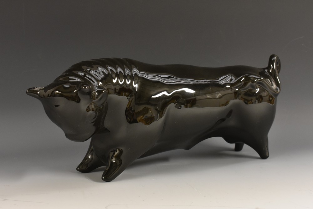 A Wedgwood model of a stylised bull, designed by Arnold Machin, glazed throughout in gloss black,