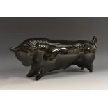A Wedgwood model of a stylised bull, designed by Arnold Machin, glazed throughout in gloss black,