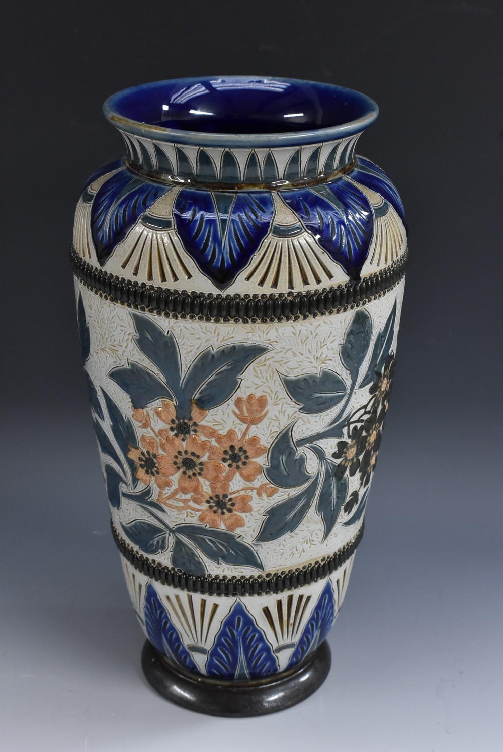 A Doulton Lambeth ovoid vase, incised with leaves and foliage, the neck with stiff leaves,