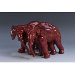 A Royal Doulton flambé elephant group, designed by Charles Noke, 7cm high,