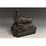 A Wedgwood black basalt model of a stylised sealion resting on a rocky outcrop,