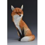 A Royal Worcester model of a red fox, seated with a guileful expression, number 2993,