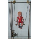 A clockwork bod on a swing, c.