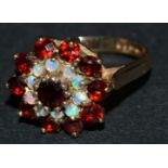 A 9ct gold cluster ring, set with garnets and opal, 3.