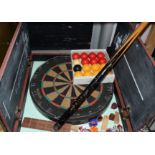 A dart board, cased, the case with chalk board interior; snooker balls,