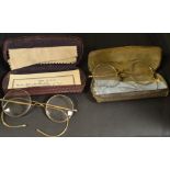 A pair of spectacles, gold coloured metal bridge, cased; another pair similar,