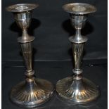 A pair of 20th century silver candlesticks, oval weighted bases,