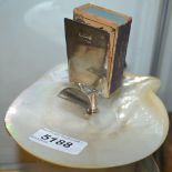 A silver and shell combination matchbox holder and ashtray, silver pedestal base,