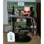 Toys - a mid 20th century child's Singer For The Girls sewing machine, black and metal body,