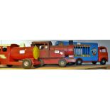 A Tri-ang pressed steel Circus Van, 59cm long; a Tri-ang push-along train, 32cm long; another,