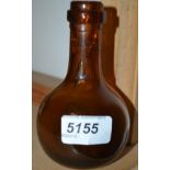 An 18th/19th century Dutch amber coloured glass onion bottle