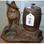 A Black Forest novelty tobacco jar, carved as a bearded gnome beside a barrel,