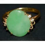 A lady's jade green stone and diamond dress ring, central oval jade green stone panel,