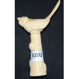 A contemporary carved bone corkscrew, the handle as a resting bird upon a removable carved trunk,