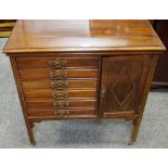 A mahogany music cabinet, moulded top, six drawers, adjacent cupboard, fluted square legs,