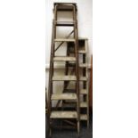 Two sets of vintage step ladders.