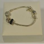 A Silver Pandora Bracelet, with three charms, two marked G585 5925 and safety chain.