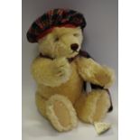 A Steiff teddy bear, with 'growling' mechanism, tartan dress,