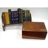 An oak book trough and books including Hilaire Belloc; Charles Dickens; Thomas Hughes;