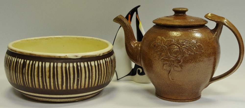 A 20th Century salt glazed teapot, a Langley mill bowl, Cmielow model of stylized penguins (3).