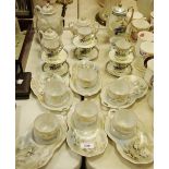 A Japanese eggshell tea service and a Japanese coffee service comprising teapot/coffee pot, cups,