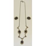 A Silver marcasite necklace, set with three blue john stones, conforming earrings.