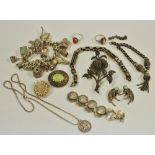 A Silver charm bracelet with treasure chest, lobster pot, typewriter, charms, etc,