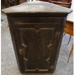 A Jacobean revival oak block front corner cupboard.