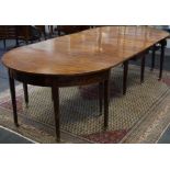 A George III mahogany dining table, formed from a central rectangular gateleg,