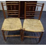 A pair of 19th century fruitwood hall chairs, rush seats,