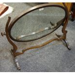 A George III mahogany oval dressing mirror.