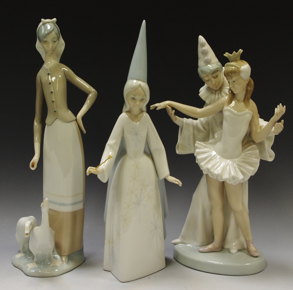 A Lladro Pierrot and Ballerina, others; lady with geese; a Fairy Godmother.